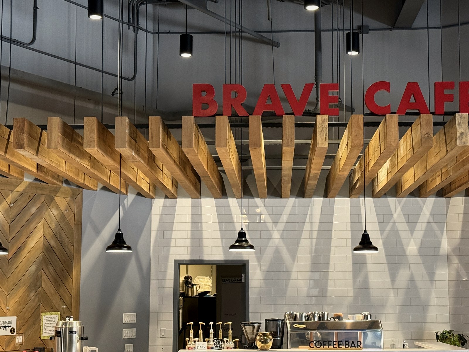 Pendant and track lighting over the Brave Cafe coffee bar after the LED retrofit