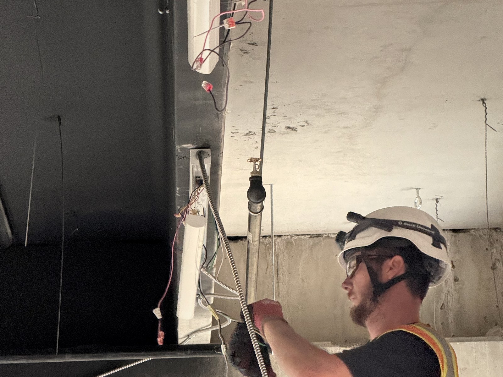 Colpitts Electric electrician running MC cable at the structural deck